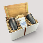 Closing Day Gifts personalized acacia wood tray set with gold handles, engraved tumblers, coasters, and candle in box.