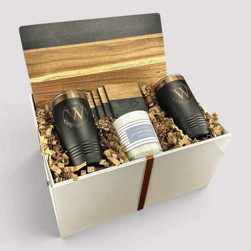 Closing Day Gifts personalized black marble and wood serving board set with two engraved tumblers and a scented candle.