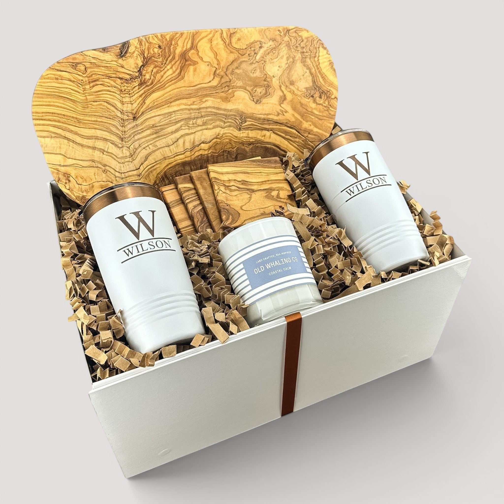 Closing Day Gifts personalized olive wood cutting board set with engraved tumblers, coasters, and candle in a gift box.