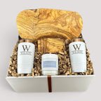 Closing Day Gifts personalized olive wood cutting board, coasters, white tumblers, and candle in a keepsake gift box.