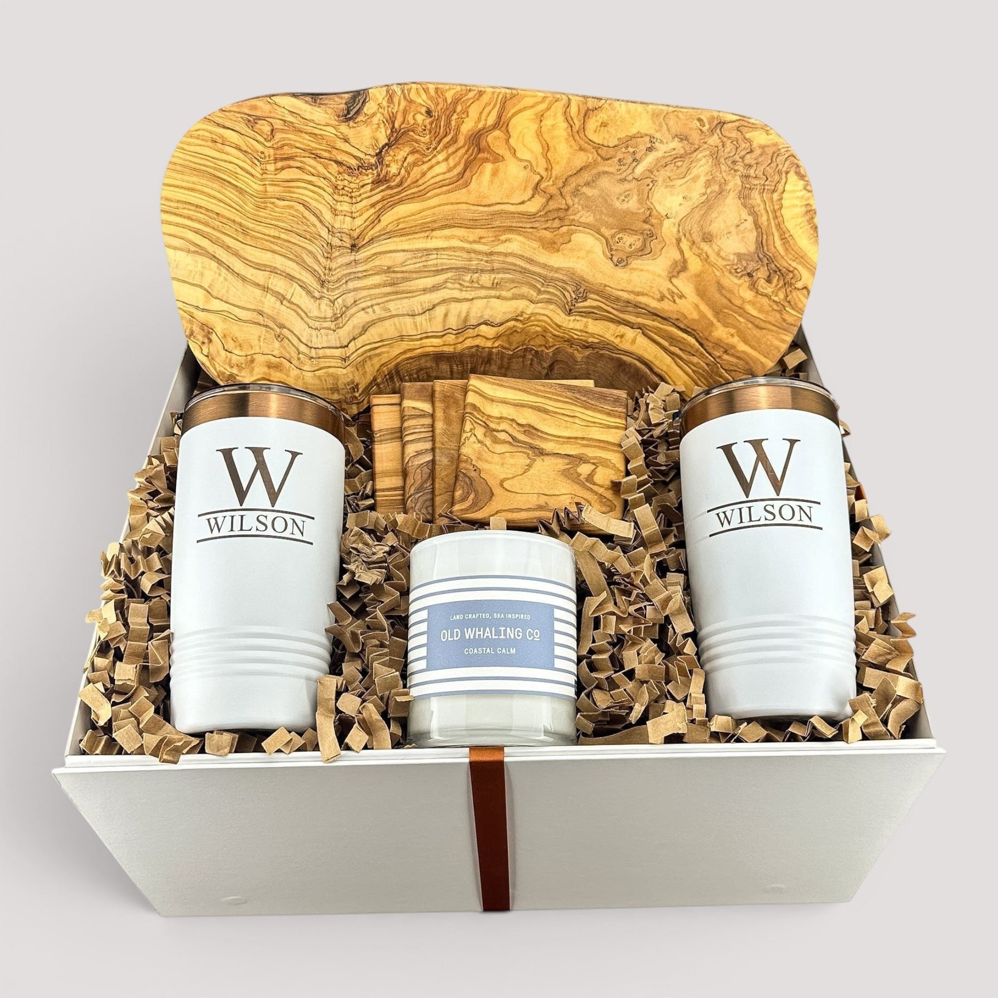 Closing Day Gifts personalized olive wood cutting board, coasters, white tumblers, and candle in a keepsake gift box.