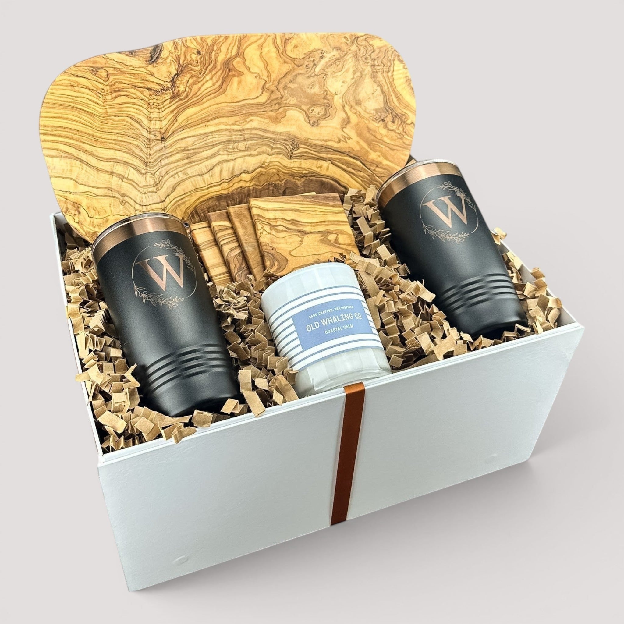 Closing Day Gifts personalized olive wood cutting board set with engraved tumblers, coasters, and a scented candle.