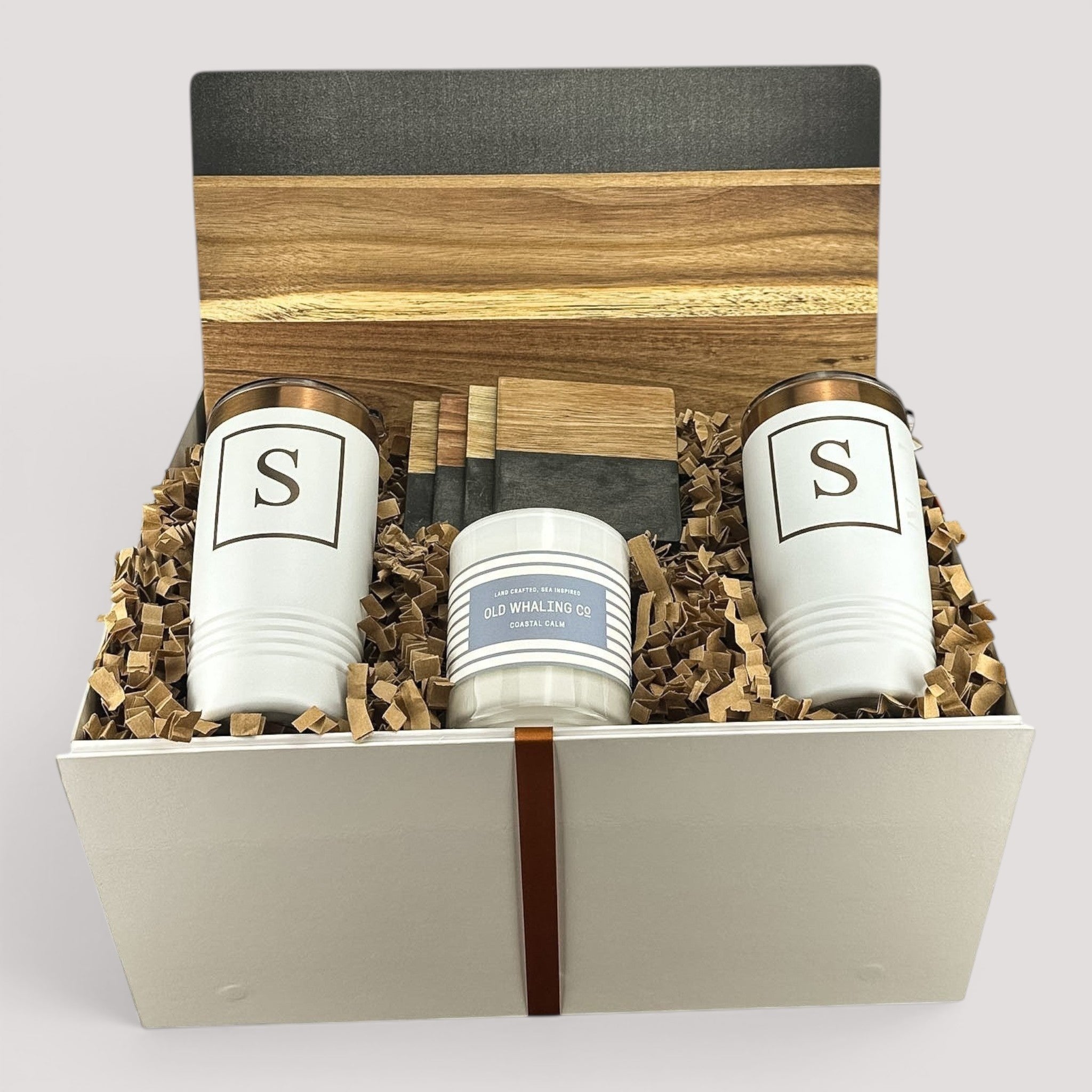 Closing Day Gifts personalized gift set with two white tumblers, marble serving board, and candle in a gift box.