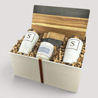 Closing Day Gifts personalized set with two white monogrammed tumblers, a scented candle, and a marble serving board.