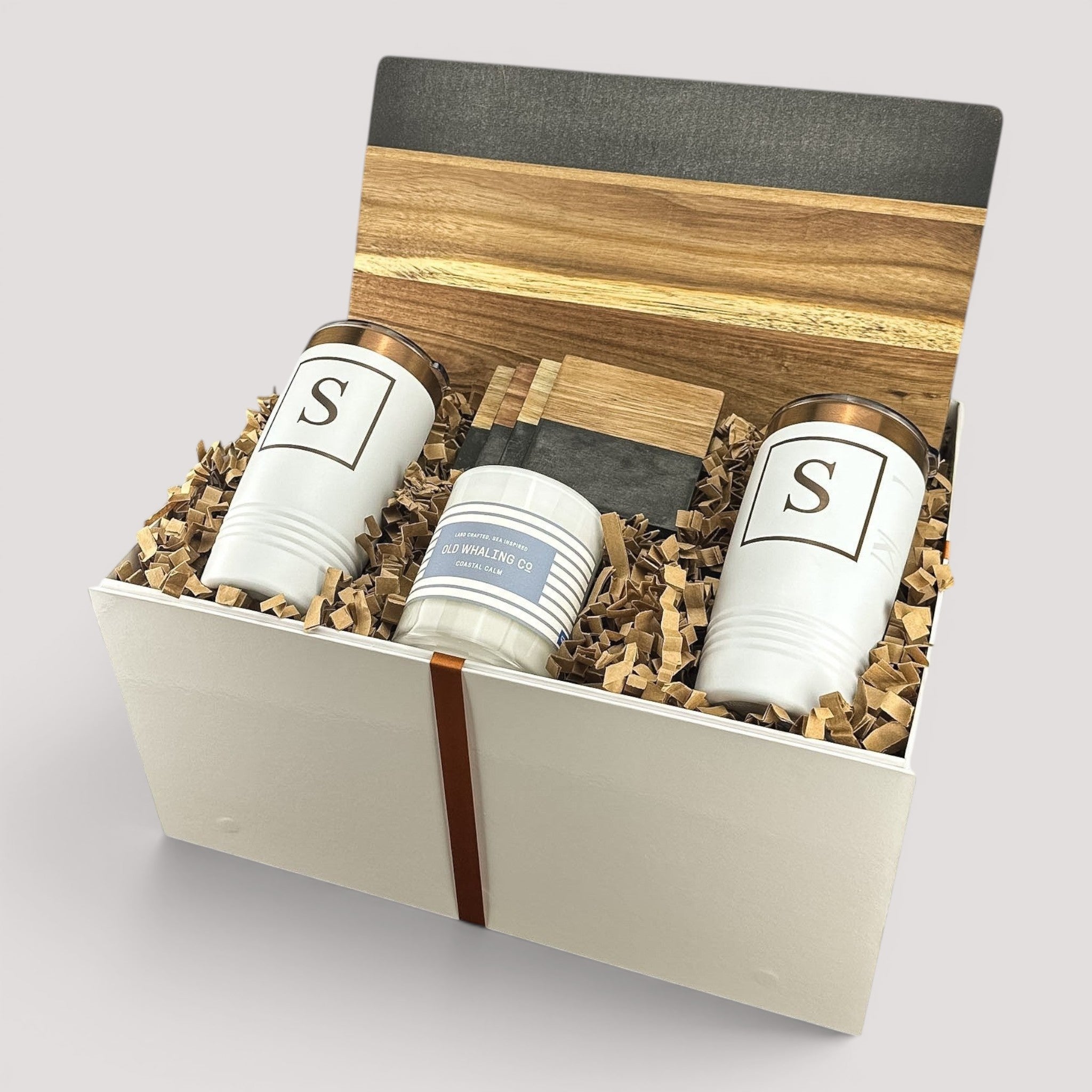 Closing Day Gifts personalized set with two white monogrammed tumblers, a scented candle, and a marble serving board.
