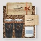 Closing Day Gifts personalized rubber wood valet tray, two black tumblers, maple coasters, and candle in a gift box.