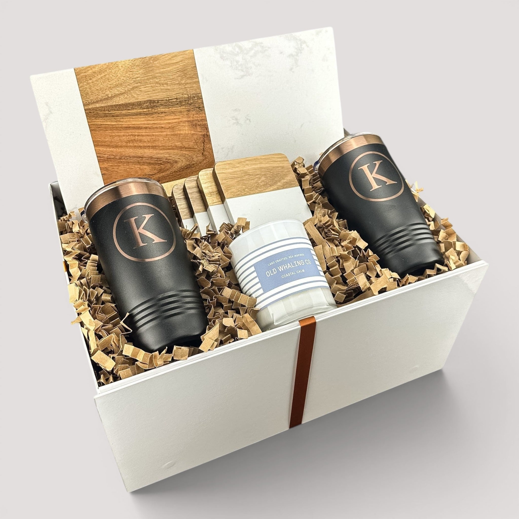 Closing Day Gifts personalized housewarming set with marble serving board, engraved tumblers, coasters, and candle in box.