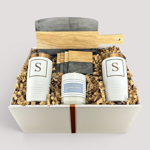 Closing Day Gifts personalized housewarming set with black marble and acacia wood board, tumblers, coasters, and candle.