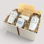 Closing Day Gifts personalized housewarming set with rubber wood cutting board, two white tumblers, coasters, and candle.