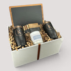 Closing Day Gifts personalized housewarming set with slate cheese board, two black tumblers, coasters, and soy candle.