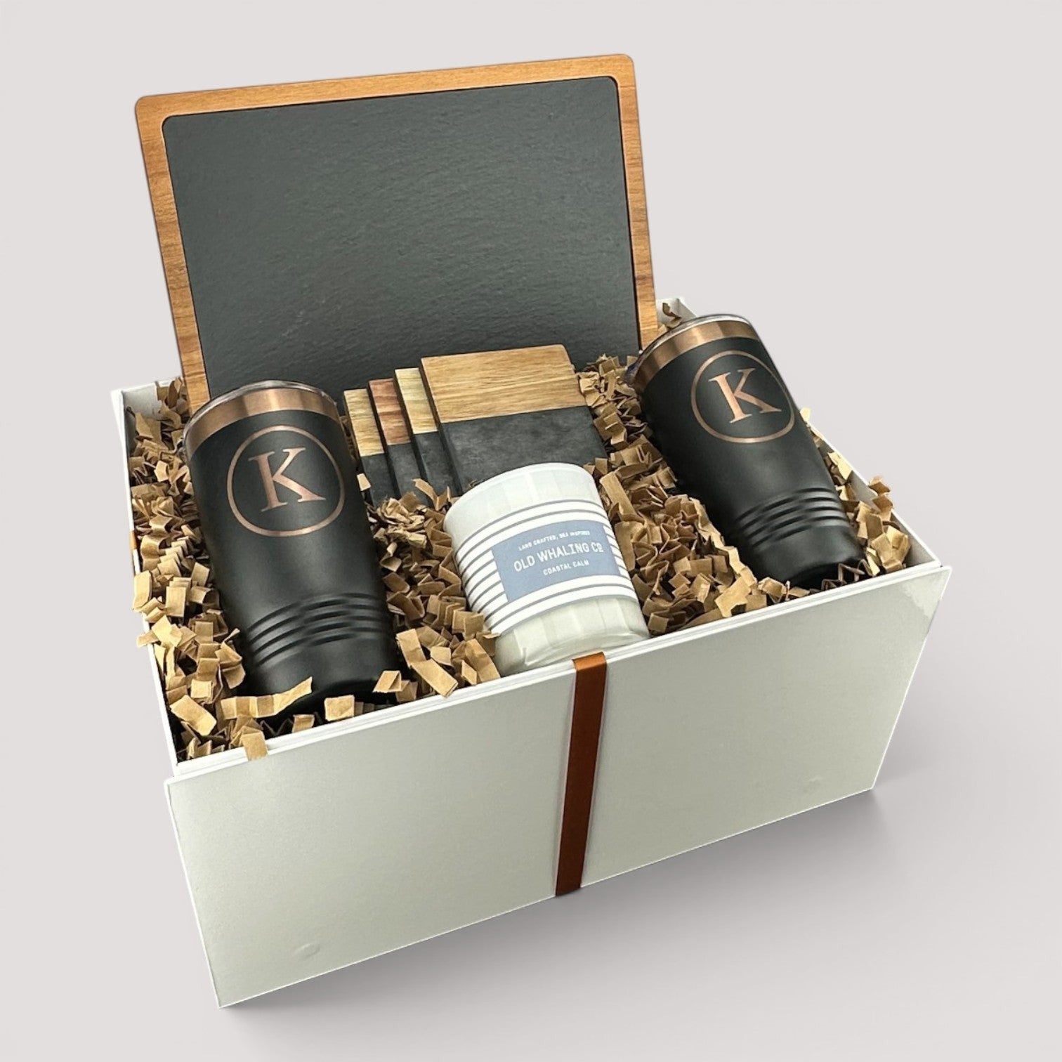 Closing Day Gifts personalized housewarming set with slate cheese board, two black tumblers, coasters, and soy candle.