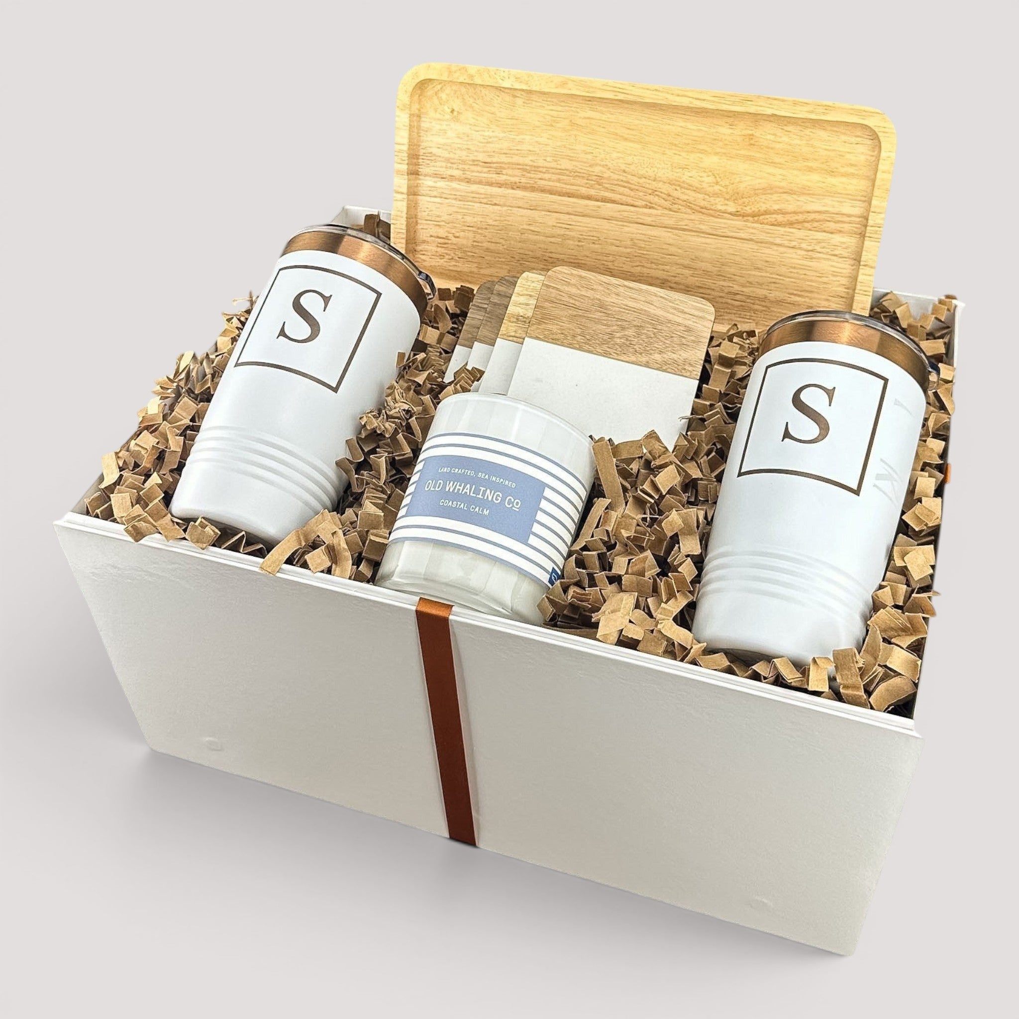 Closing Day Gifts personalized housewarming set with rubber wood tray, two white tumblers, coasters, and candle in box.