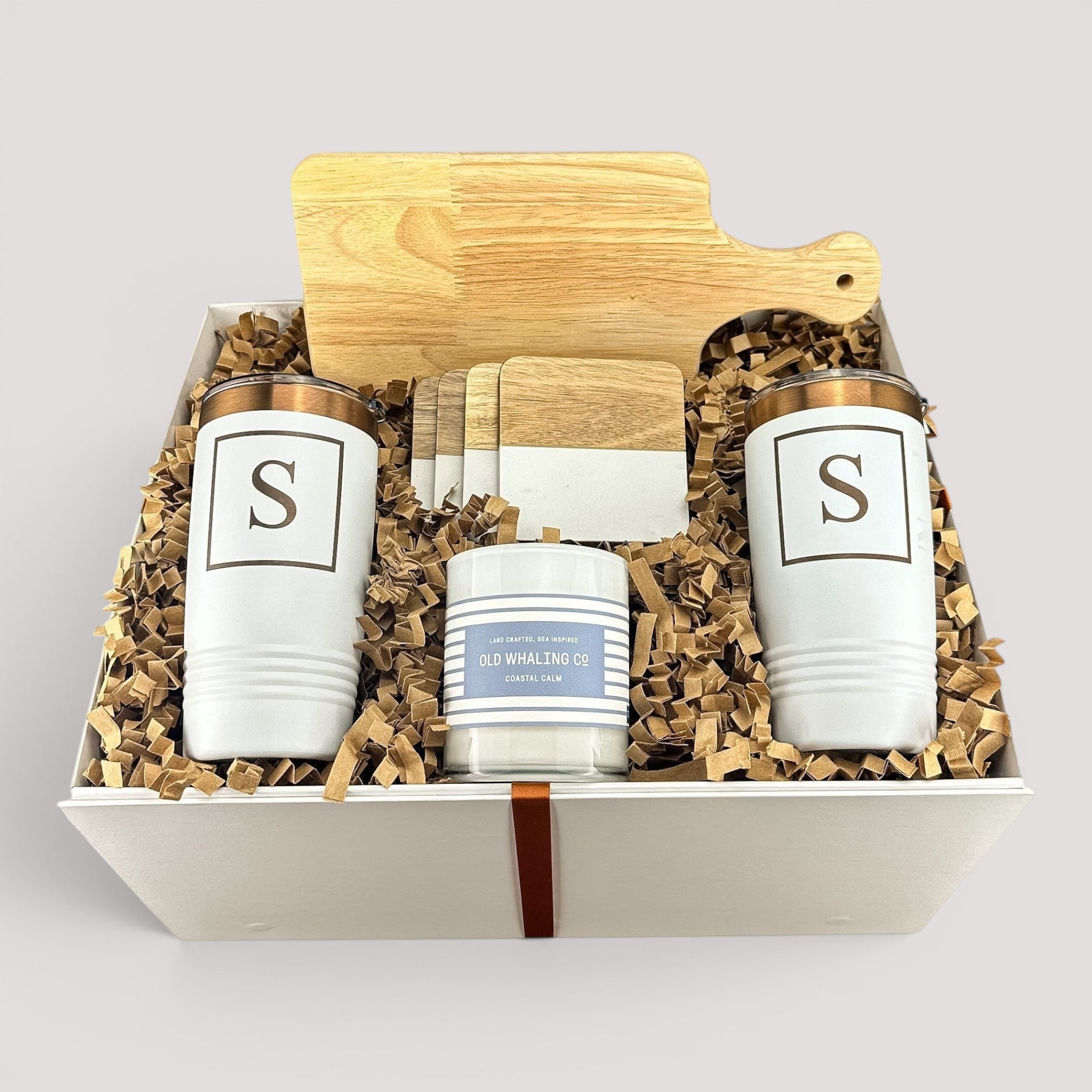 Closing Day Gifts personalized housewarming set with rubber wood cutting board, two tumblers, coasters, and candle.