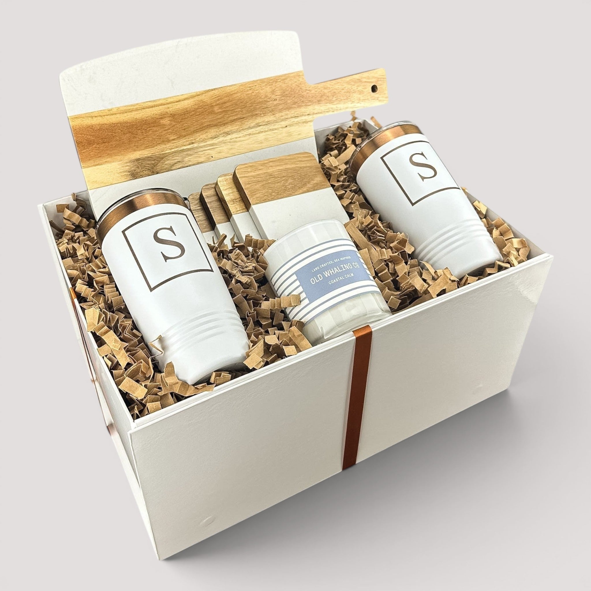 Closing Day Gifts personalized housewarming set with marble serving board, engraved tumblers, coasters, and candle.