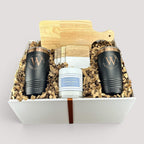 Closing Day Gifts personalized housewarming set with rubber wood cutting board, black tumblers, coasters, and candle.