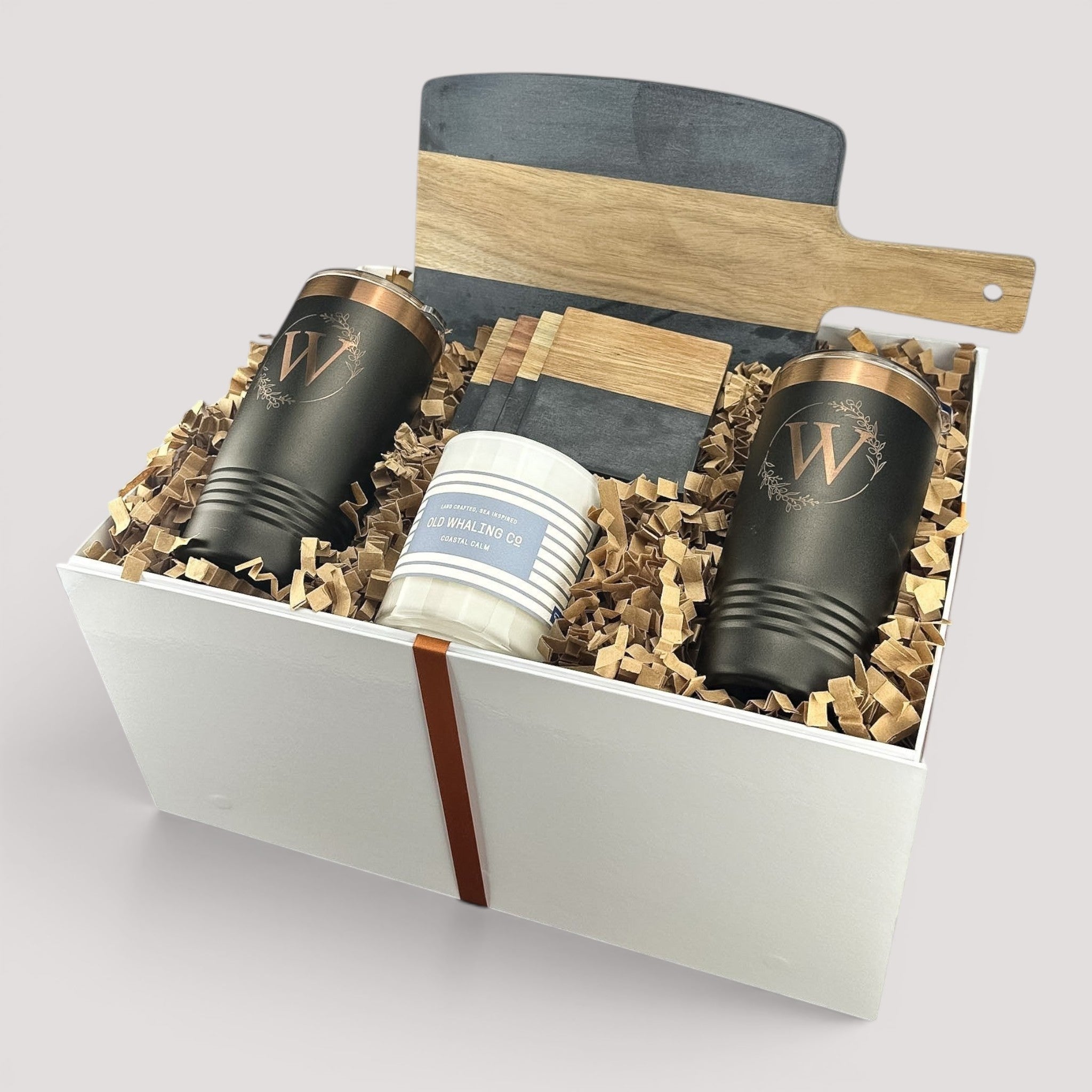 Closing Day Gifts personalized housewarming set with black marble and acacia board, tumblers, coasters, and candle.