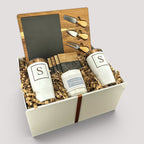 Closing Day Gifts personalized housewarming set with slate cheese board, tumblers, coasters, and candle in a gift box.