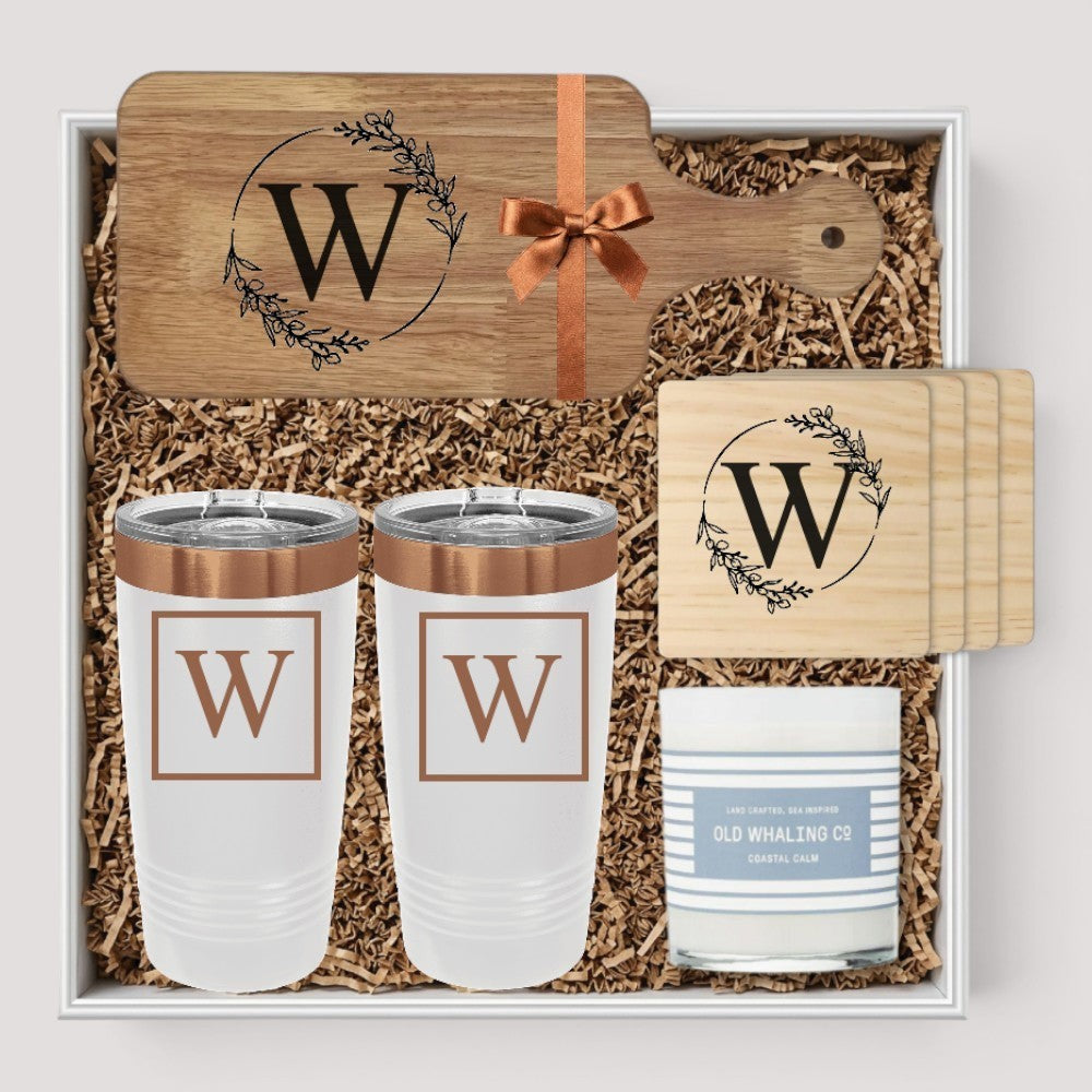 Closing Day Gifts personalized housewarming set with engraved rubber wood cutting board, two tumblers, coasters, and candle.