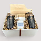 Closing Day Gifts personalized housewarming set with maple cutting board, black tumblers, marble coasters, and candle.