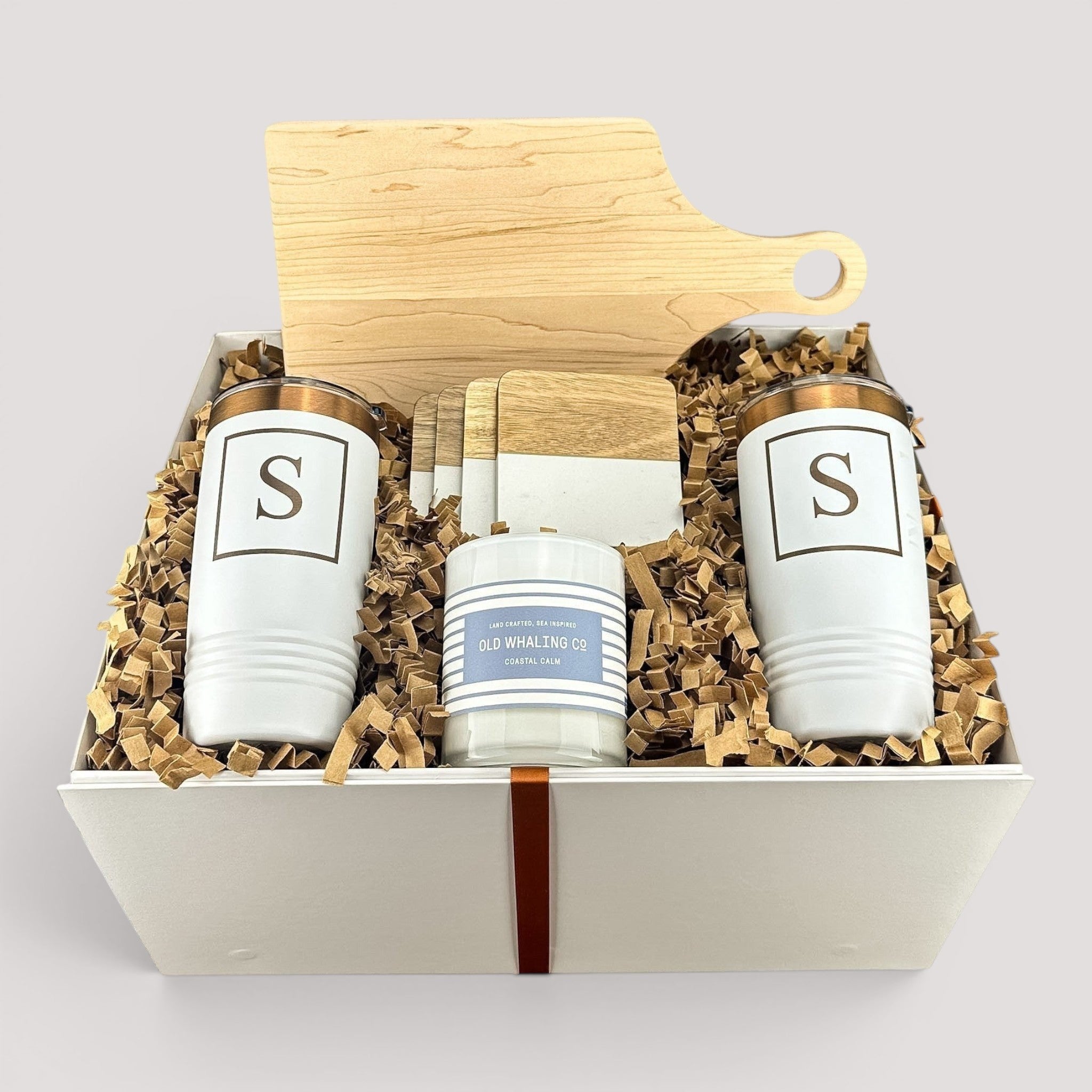 Closing Day Gifts personalized housewarming set with maple cutting board, white tumblers, marble coasters, and candle.