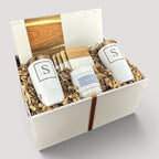 Closing Day Gifts personalized housewarming set with marble and acacia board, engraved tumblers, coasters, and candle.