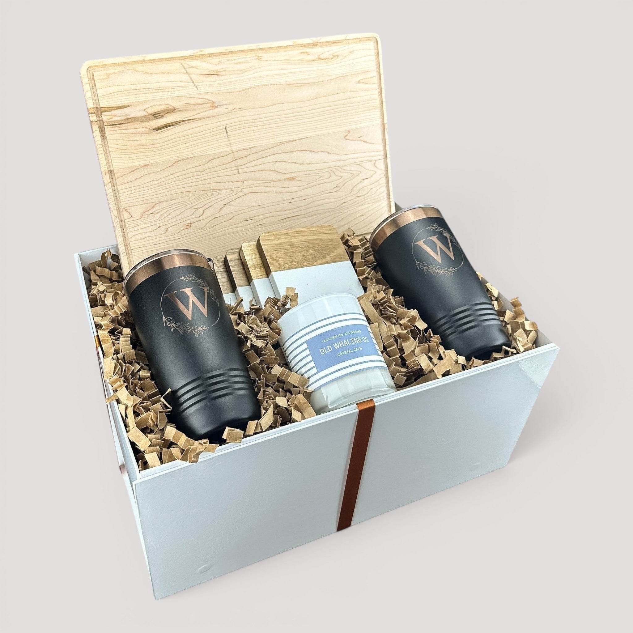 Closing Day Gifts personalized housewarming set with maple cutting board, black tumblers, marble coasters, and candle.