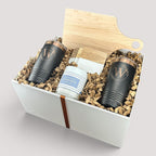 Closing Day Gifts personalized housewarming set with maple cutting board, black tumblers, marble coasters, and candle.
