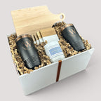 Closing Day Gifts personalized housewarming set with maple cutting board, black tumblers, marble coasters, and candle.