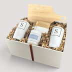 Closing Day Gifts personalized housewarming set with maple cutting board, white tumblers, coasters, and candle.