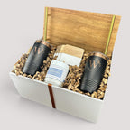 Closing Day Gifts personalized housewarming set with engraved black tumblers, marble coasters, and a scented candle.