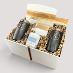 Closing Day Gifts personalized housewarming set with marble and acacia board, black tumblers, coasters, and candle.