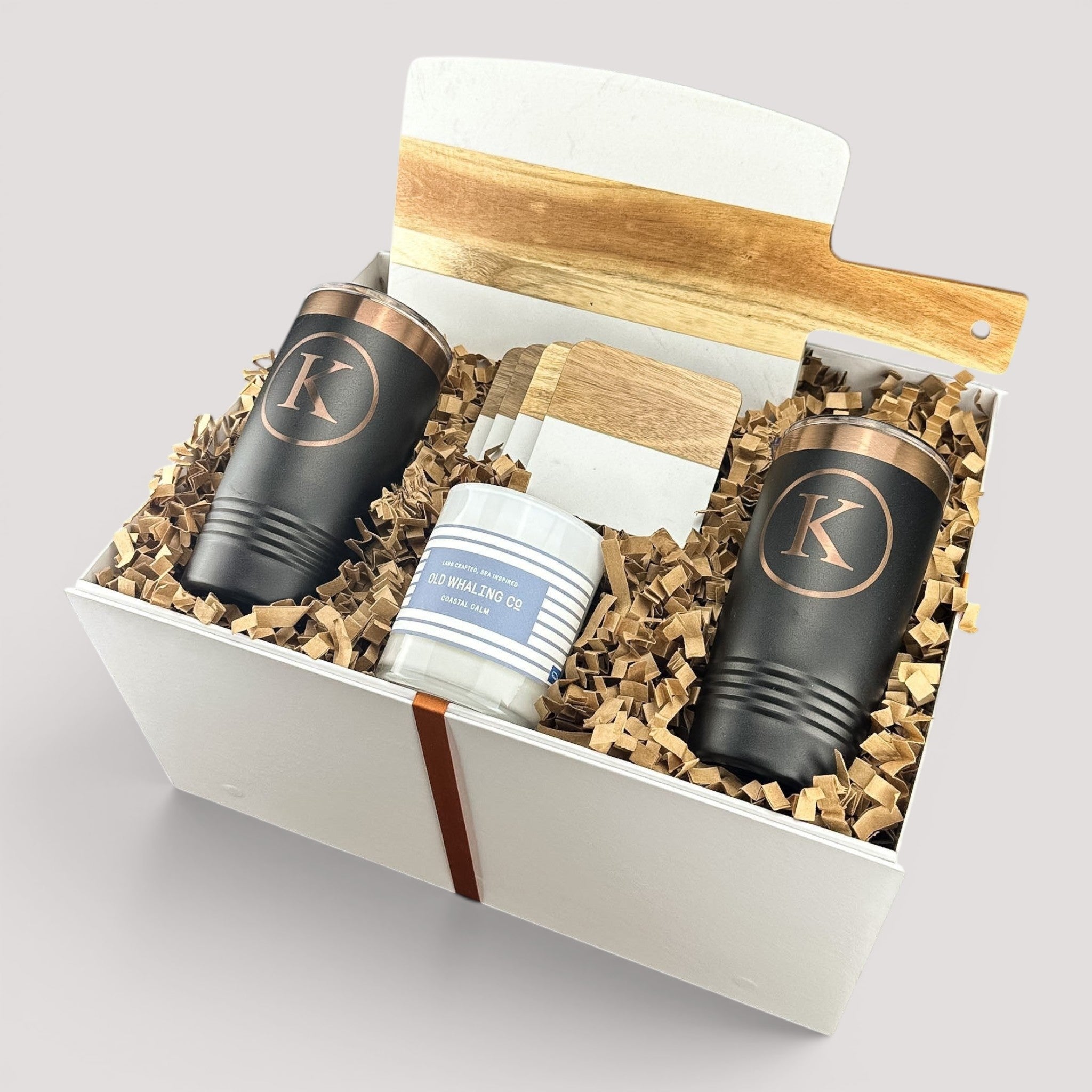 Closing Day Gifts personalized housewarming set with marble and acacia board, black tumblers, coasters, and candle.