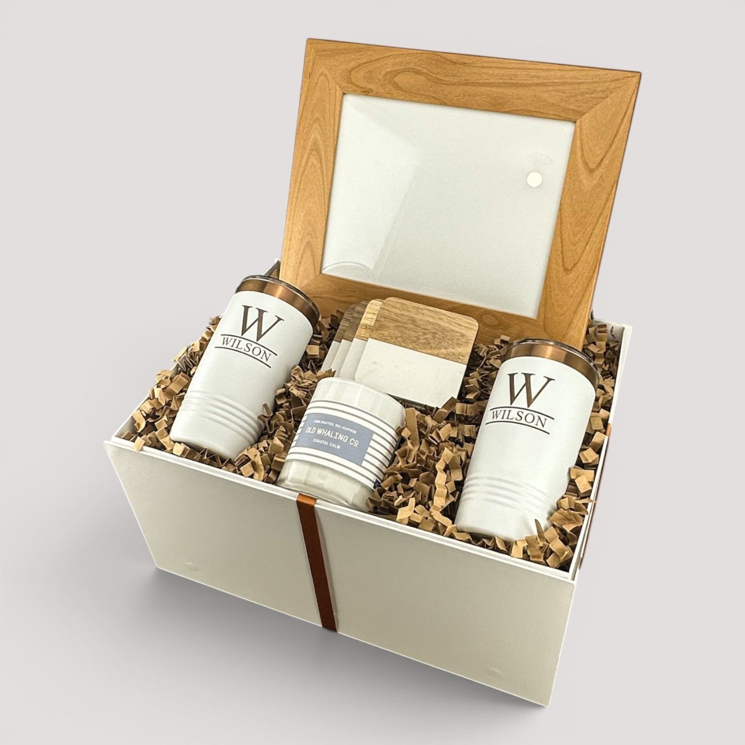 Closing Day Gifts personalized housewarming set with engraved tumblers, marble coasters, candle, and framed art.
