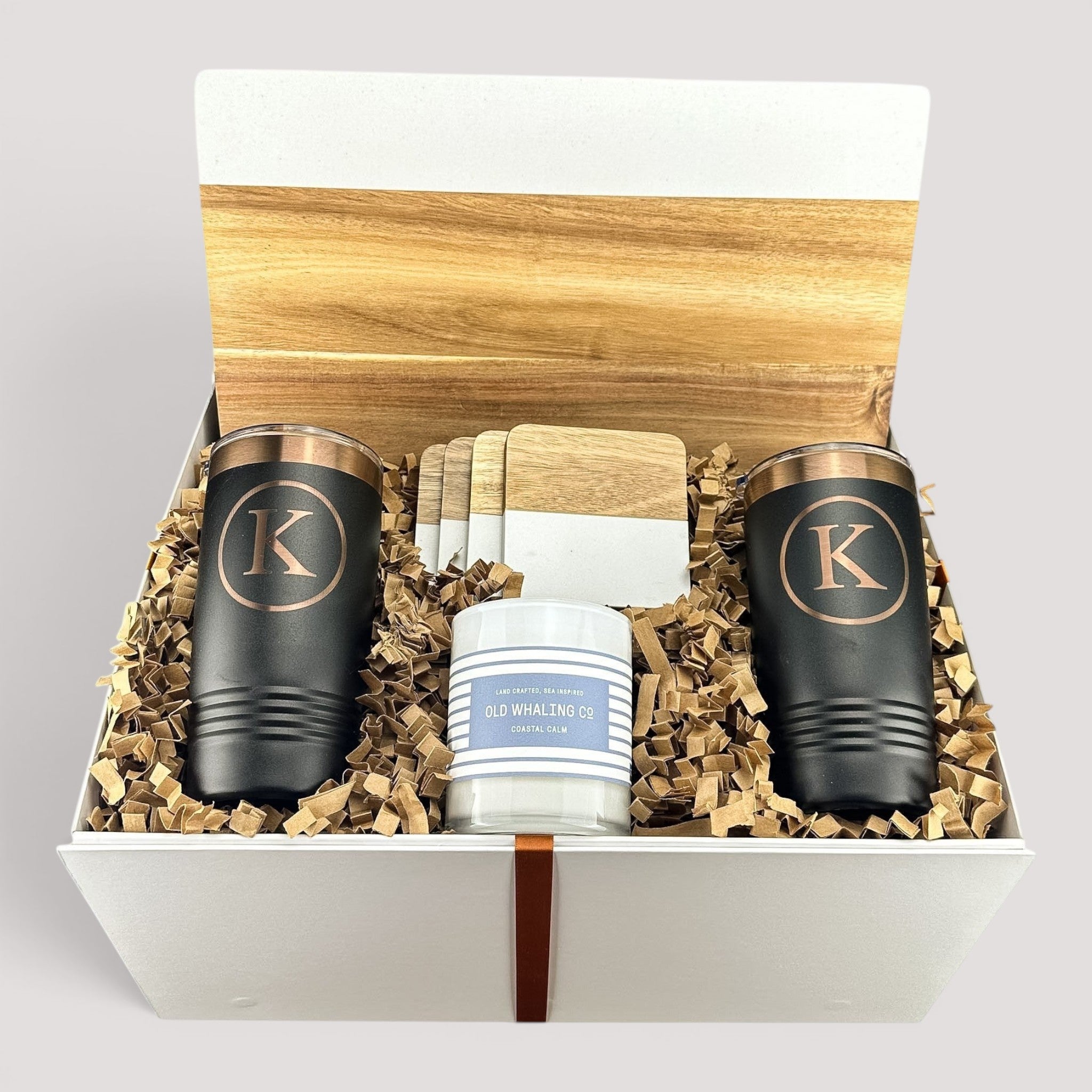 Closing Day Gifts personalized housewarming set with marble and acacia board, black tumblers, coasters, and candle.