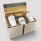Closing Day Gifts personalized set with black marble serving board, two white tumblers, and a scented candle in a box.