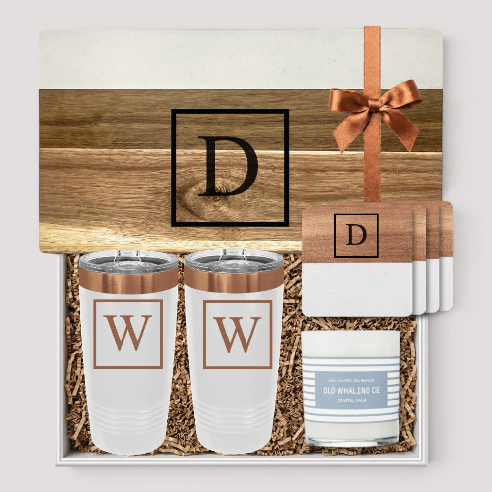 Closing Day Gifts personalized serving board set with marble and acacia coasters, tumblers, and candle in a gift box.