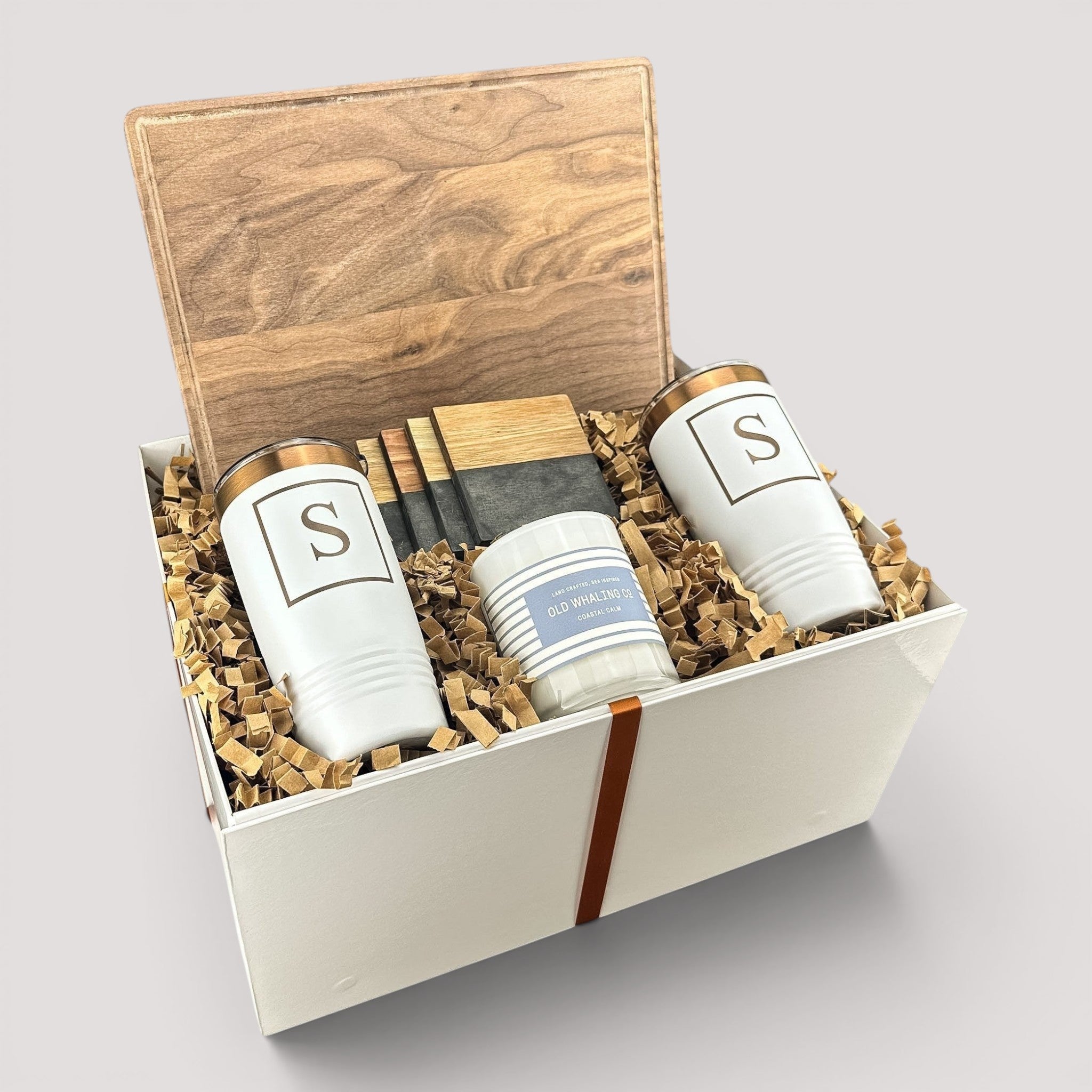 Closing Day Gifts personalized walnut cutting board, engraved tumblers, marble coasters, and candle in a keepsake box.