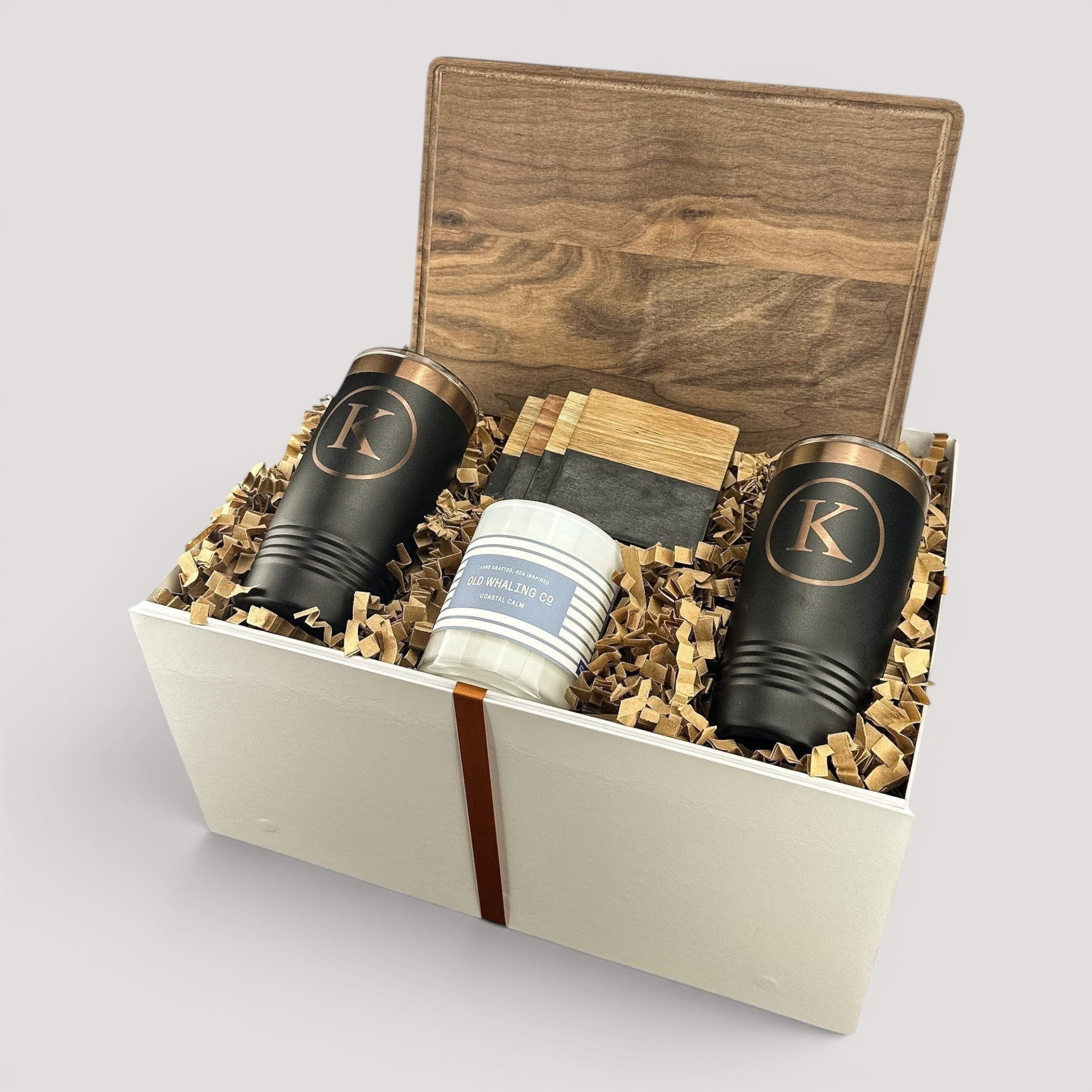 Closing Day Gifts personalized walnut cutting board set with engraved tumblers, marble coasters, and a scented candle.