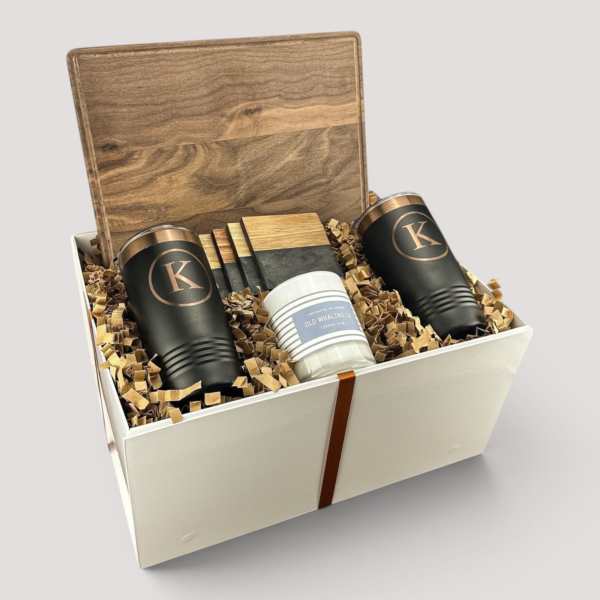 Closing Day Gifts personalized walnut cutting board set with engraved tumblers, marble coasters, and a scented candle.